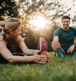 a man and woman doing a stretching exercise