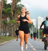 a woman running on a bike and a man riding a bike