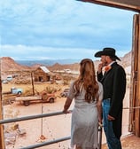 a man and woman standing in front of a door