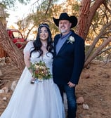 a man and woman in cowboy hats and wedding gowns