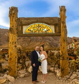 a man and woman standing in front of a stained glass window