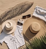 a hat with a hat on top of a beach