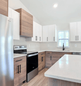 Modern kitchen remodeling in Kissimmee, FL with quartz countertops, shaker cabinets, and LED lightin