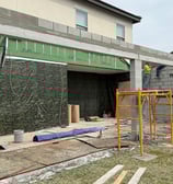 Ongoing porch renovation project featuring concrete slab and custom structural supports by top remod