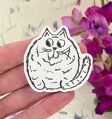 a person holding a sticker with a cat