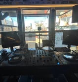 a dj booth at The Lot Radio -NYC, with a laptop and a laptop