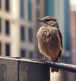 a bird perched on a railing with a city in the background