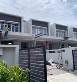 a man on a ladder in front of a building