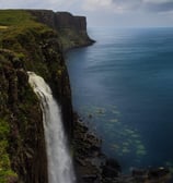 a waterfall in the middle of a cliff