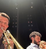 Trumpeters George Chase and Chris Coletti warm up before a dress rehearsal for a chamber orchestra.