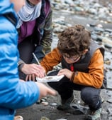 Beach combing by the shore having fun