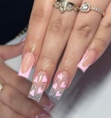 a woman's hand painted nails and a ring