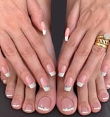 a woman's feet with a wedding ring on her finger
