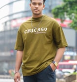 a man in a green shirt and black pants