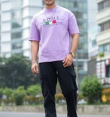 a man in a purple shirt and black pants