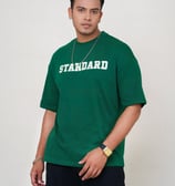 a man in a green shirt and a necklace