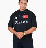 a man in a black shirt and a necklace with a turkish flag