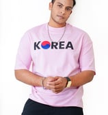 a man in a pink shirt and black pants