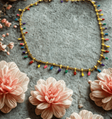 a necklace with flowers and beads on it