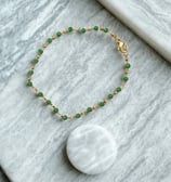 a bracelet bracelet with a white and green beaded bracelet