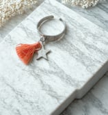 a ring with a starfish charm and a starfish charm