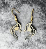 a pair of earrings with a horse head and a horse head
