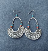 a pair of earrings with beads and pearls