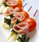 a long - terme of meat and vegetables on a white plate