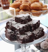 a cake with chocolate frosted sugar - covered chocolates