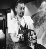 a man dressing someone's hair