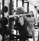 a woman doing a barbell squat