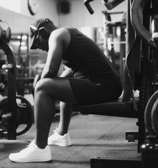 a man in a black and white photo of a man in a gym