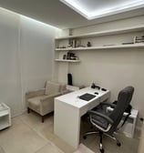 a desk with a chair and a chair in a room