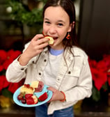 Girl enjoys eating little smoky in a Smoky Lil Bun at a party.