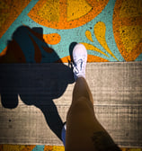 a person standing on a skateboard with their feet on the ground