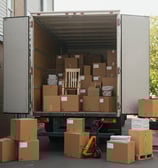 A box truck filled with moving boxes and furniture.