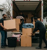 Men moving boxes into a truck.
