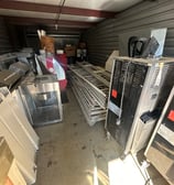 A storage unit filled with old junk appliances.
