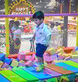 a young boy playing with blocks on a playground