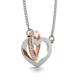 a heart shaped pendant with two hearts on it