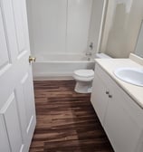 Clean bathroom beige cabinet and bathtub