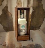 Botella de Lu Mezcal con fondo de pared desgastada