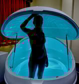 Cindy in Elite Clinic in the Dreampod with soft blue lighting 