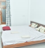 a bed with a white bed and a window