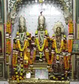 a group of three statues of hindu deities