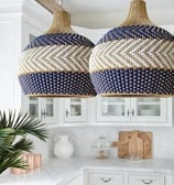 two large blue and white lamps hanging from a kitchen island