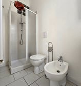 a bathroom with a toilet and a shower