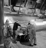a man in a metal workbend with a large metal pipe