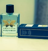 a perfume bottle and a box of perfumes