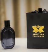 a black perfume bottle with a black box and a black box with a crown on